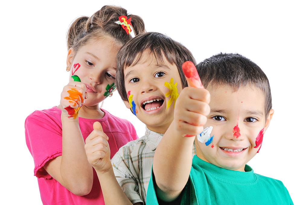 Messy children with paint on their hands and faces with thumbs u Messy children with paint on their hands and faces with thumbs u